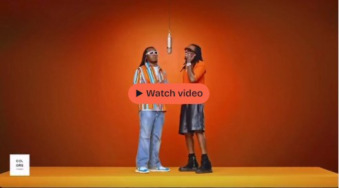 Video preview of two performers beneath a hanging microphone on the orange Hotel Lobby stage
